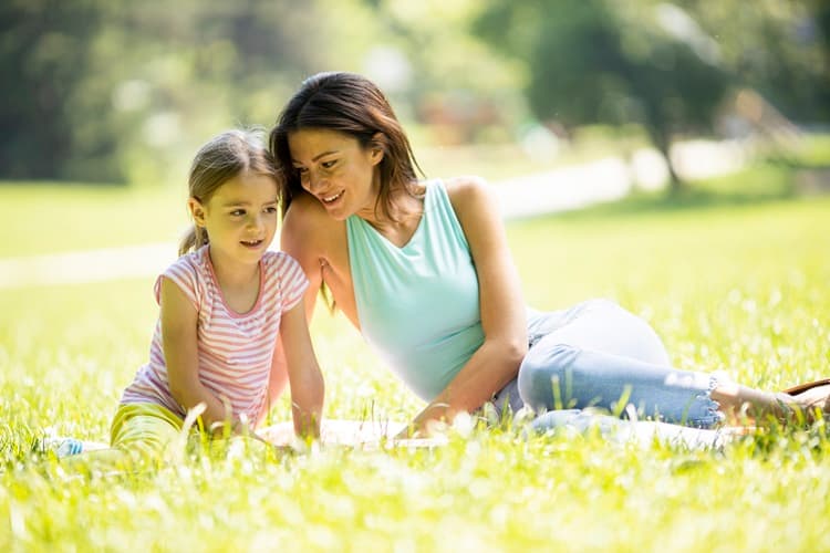 A mother and child playing in a park.